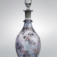 01 Karafa se zátkou, 19. století, nafialovělé průsvitné sklo, barevný email, výška 35 cm, průměr dna 9,6 cm.